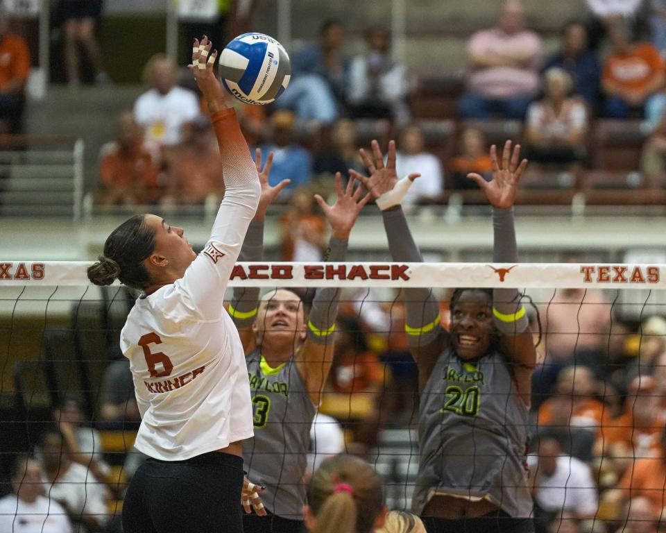 Baylor's Averi Carlson, center, tries to block Texas outside hitter Madisen Skinner in a match in October. Carlson, an all-regional setter, announced on Tuesday that she will transfer to Texas.