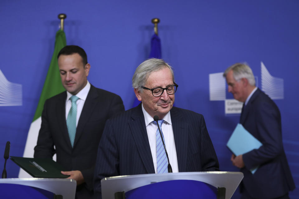 Irish Prime Minister Leo Varadkar, left, European Commission President Jean-Claude Juncker, centre, and European Union chief Brexit negotiator Michel Barnier, background right, arrive for a news conference at the European Commission headquarters in Brussels, Wednesday, Feb. 6, 2019. (AP Photo/Francisco Seco)