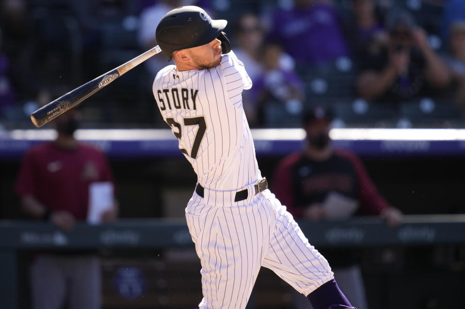 Colorado Rockies' Trevor Story follows the flight of his walkoff, solo home run off Arizona Diamondbacks relief pitcher Stefan Crichton in the ninth inning of a baseball game Sunday, May 23, 2021, in Denver. (AP Photo/David Zalubowski)