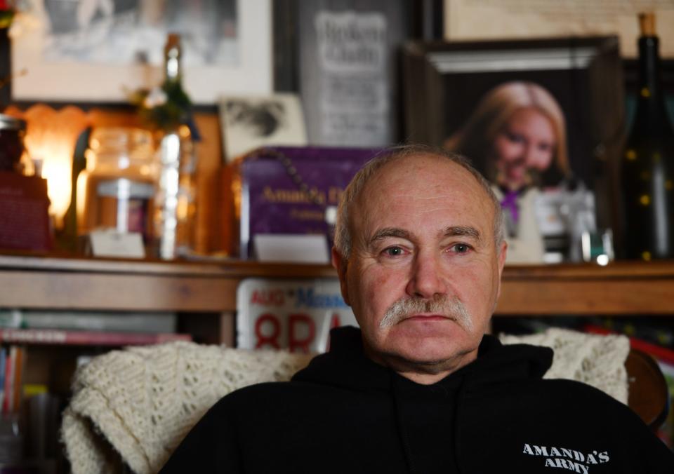 Ed Dabrowski sits in a chair in front of a memorial for his murdered daughter Amanda, set up in the living room on Wednesday, February 19, 2020.