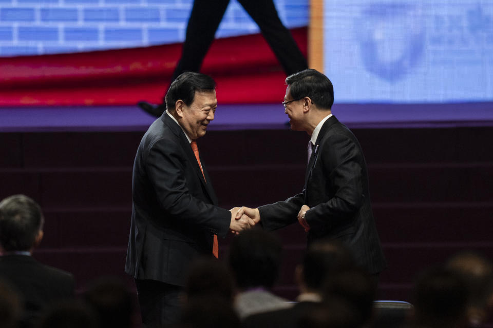 Xia Baolong, Director of the Hong Kong and Macau Affairs Office of the State Council, and John Lee, Chief Executive of Hong Kong, shake hands at the National Security Education Day opening ceremony in Hong Kong in Hong Kong, Saturday, April 15, 2023. China’s senior official overseeing Hong Kong’s affairs said holding demonstrations is not the only way to express people’s views weeks after the city’s strict demonstration rules sparked controversies, signaling Beijing’s vision for the financial hub. (AP Photo/Louise Delmotte)