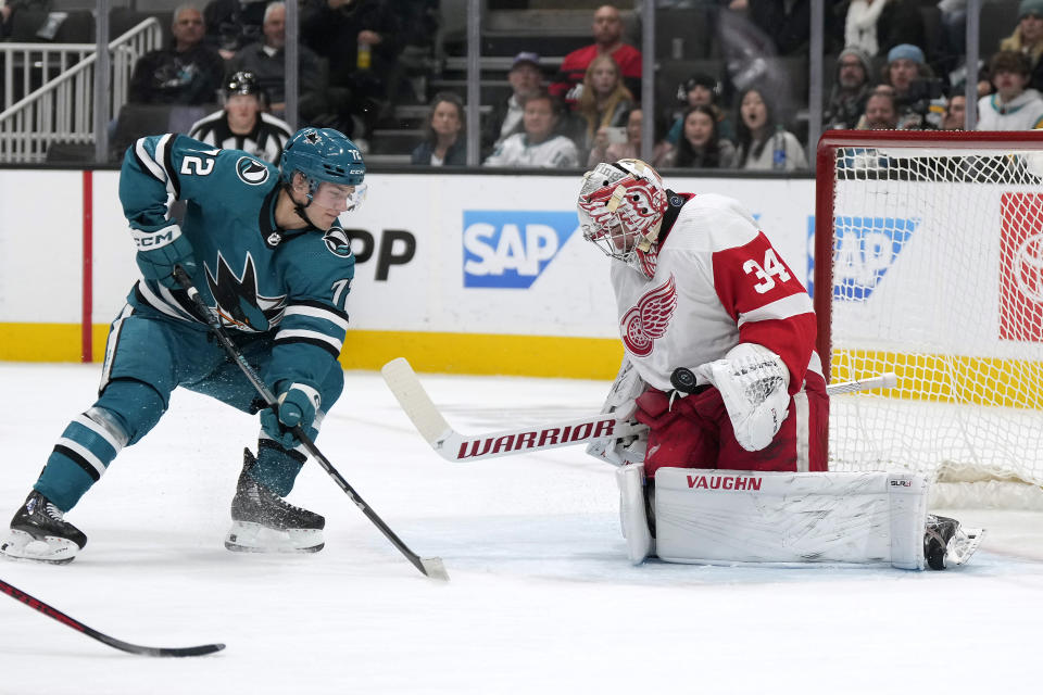 Detroit Red Wings goaltender Alex Lyon (34) blocks a shot by San Jose Sharks left wing William Eklund (72) during the first period of an NHL hockey game Tuesday, Jan. 2, 2024, in San Jose, Calif. (AP Photo/Tony Avelar)