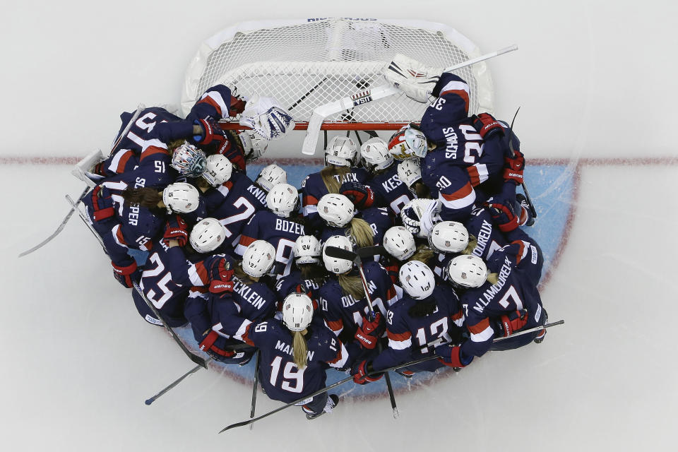 Team USA huddles around the net before the game against Switzerland during the 2014 Winter Olympics women's ice hockey game at Shayba Arena, Monday, Feb. 10, 2014, in Sochi, Russia. (AP Photo/Matt Slocum )