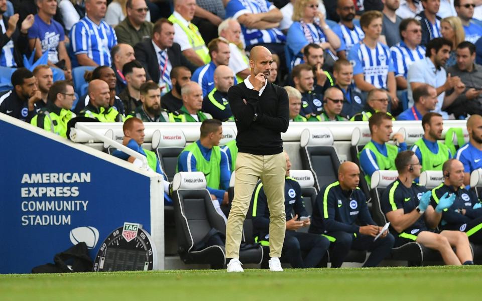 Pep in light trousers at Brighton in 2017 - REUTERS