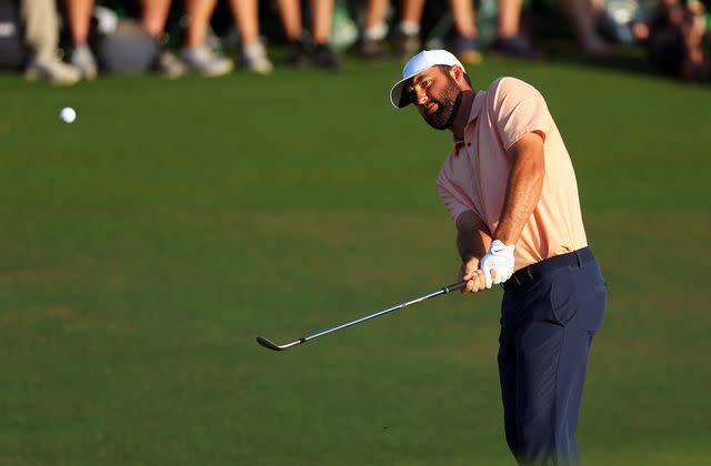 <p>Andrew Redington/Getty </p> Scottie Scheffler plays his shot on the 18th hole during the final round of the 2024 Masters Tournament at Augusta National Golf Club on April 14, 2024.