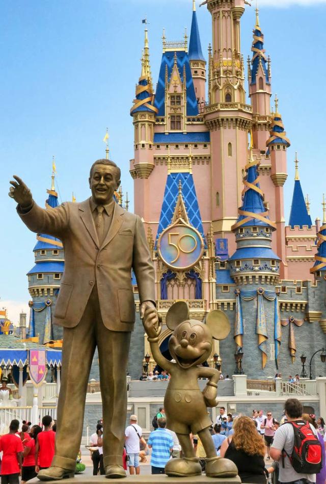 walt disney and mickey mouse holding hands