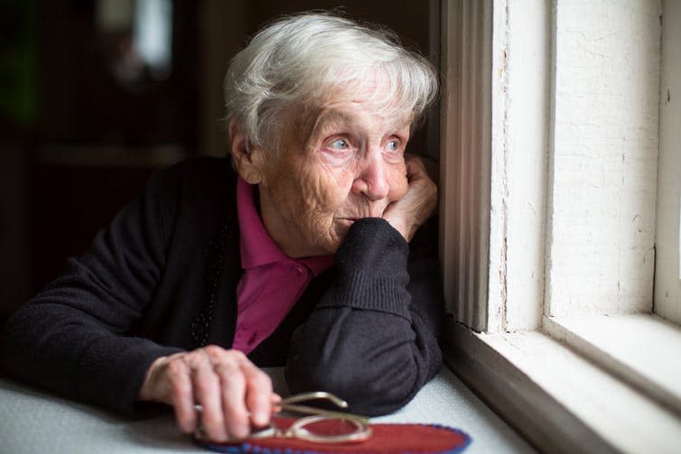 <span class="caption">Austerity policies in the UK have meant that the safety net for old people has been eroded.</span> <span class="attribution"><a class="link " href="https://www.shutterstock.com/image-photo/elderly-woman-looks-sadly-out-window-521175373" rel="nofollow noopener" target="_blank" data-ylk="slk:Shutterstock;elm:context_link;itc:0;sec:content-canvas">Shutterstock</a></span>