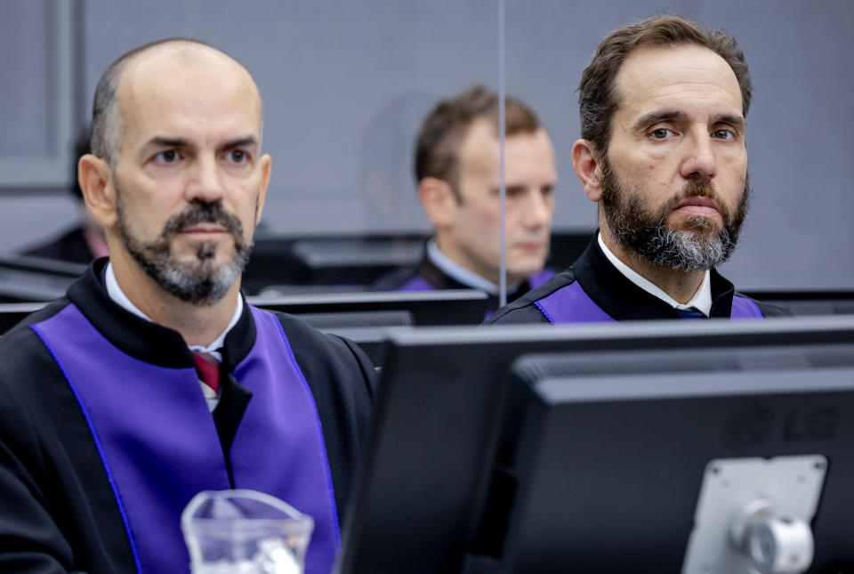 FILE - Prosecutor Jack Smith, right, and Cezary Michalczuk, left, wait for the start of the trial against Salih Mustafa at the Kosovo Specialist Chambers court in The Hague, Sept. 15, 2021. Smith, the prosecutor named as special counsel to oversee investigations related to former President Donald Trump, has a long career confronting public corruption and war crimes. (Robin van Lonkhuijsen/Pool Photo via AP)
