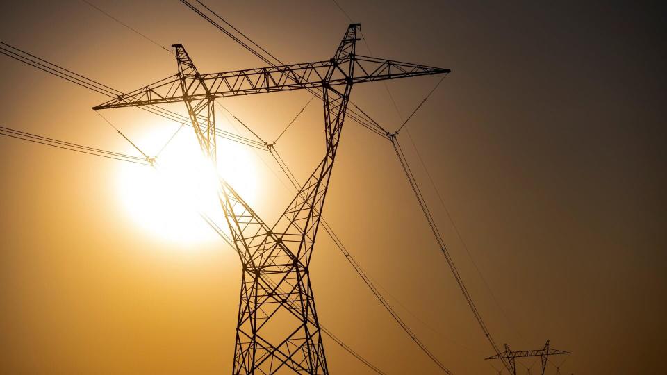 UNITED STATES - AUGUST 19: High tension power lines stretch across the desert lanscape at sunrise near Boulder City, Nev.