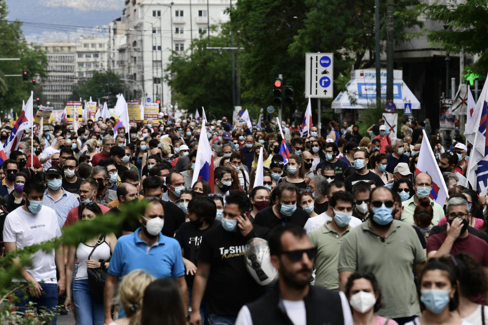 Supporters of the Greek communist party-affiliated PAME labor union march during a rally in Athens, Thursday, June 10, 2021. Widespread strikes in Greece brought public transport and other services to a halt Thursday, as the country's largest labor unions protested against employment reforms they argue will make flexible workplace changes introduced during the pandemic more permanent. (AP Photo/Michael Varaklas)