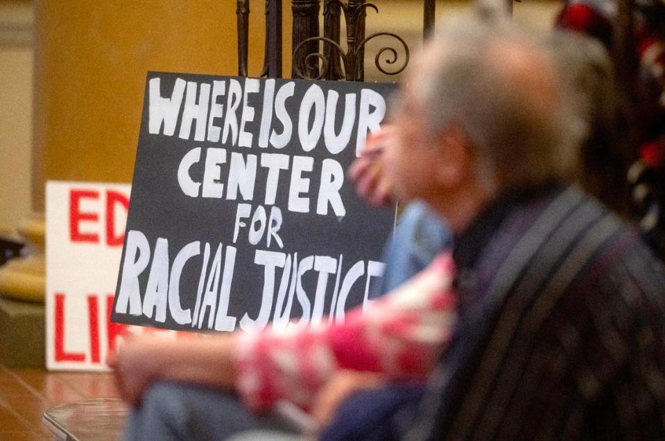 A poster asking “where is our center for racial justice” sits next to listeners of the read-in for social justice in the lobby of Penn State’s Old Main on Tuesday, April 16, 2024. Abby Drey/adrey@centredaily.com