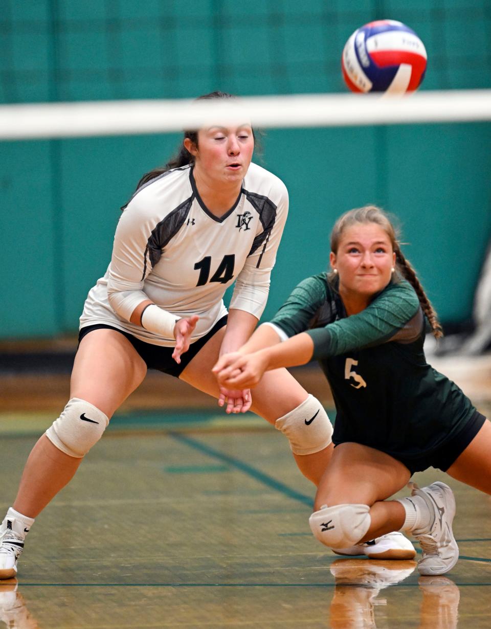 Ellen Swanson dives in front of her D-Y teammate Ryann Johnson to dig out a Barnstable serve during a Sept. 18, 2023 match.