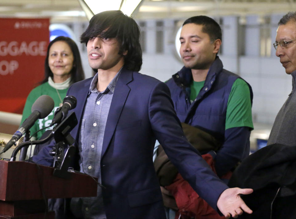 Shezanne Cassim, accompanied by his family, meets the media after he arrived at the Minneapolis-St. Paul International Airport, Thursday, Jan. 9, 2014 in Minneapolis after being held in a maximum security prison since June since June in the United Arab Emirates for a parody video that was posted online. (AP Photo/Jim Mone)