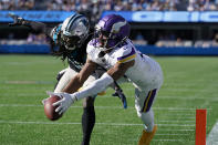Minnesota Vikings wide receiver Justin Jefferson (18) attempts a catch against Carolina Panthers cornerback Donte Jackson (26) during the second half of an NFL football game, Sunday, Oct. 17, 2021, in Charlotte, N.C. Jefferson didn't score on the play. (AP Photo/Gerald Herbert)