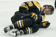 Boston Bruins right wing David Pastrnak (88) crumples to the ice after he was slashed by New York Islanders right wing Leo Komarov in the first period of an NHL hockey game, Monday, May 10, 2021, in Boston. (AP Photo/Elise Amendola)