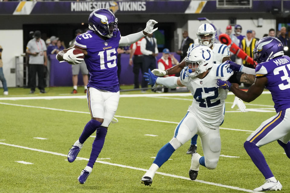 Minnesota Vikings wide receiver Ihmir Smith-Marsette (15) runs from Indianapolis Colts linebacker Curtis Bolton (42) while returning a kickoff during the second half of an NFL football game, Saturday, Aug. 21, 2021, in Minneapolis. (AP Photo/Jim Mone)
