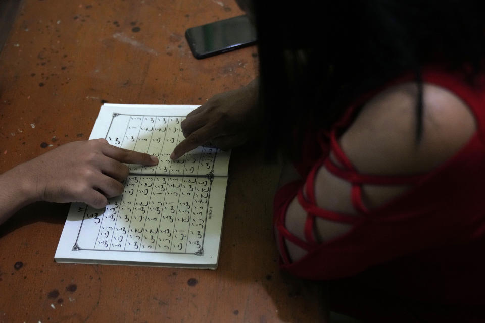 A trans woman learns to read Arabic during a class at Al Fatah Islamic school in Yogyakarta, Indonesia, Sunday, Nov. 6, 2022. The school whose students are transgender women is a rare oasis of LGBTQ acceptance – not only in Indonesia, but across the far-flung Muslim world. (AP Photo/Dita Alangkara)