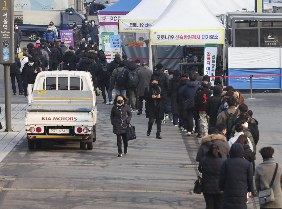 People wait for their coronavirus test at a makeshift testing site in Seoul, South Korea, Saturday, Feb. 26, 2022. South Korea had its deadliest day of the pandemic on Saturday, reporting more than a hundred fatalities in the latest 24-hour period, as it grapples with its most severe wave of coronavirus infections driven by the fast-moving omicron variant.(Ryu Hyung-seok/Yonhap via AP)