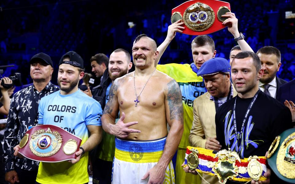 Oleksandr Usyk celebrates with their belts and team after their victory over Anthony Joshua in their World Heavyweight Championship - Francois Nel /Getty Images