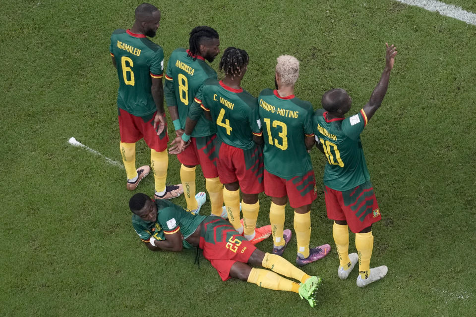 Cameroon's Tolo Nouhou, on the ground, takes his place on the wall before a free kick during the World Cup group G soccer match between Cameroon and Brazil, at the Lusail Stadium in Lusail, Qatar, Friday, Dec. 2, 2022. (AP Photo/Thanassis Stavrakis)