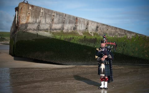 Lone Piper Major Trevor Macey-Lillie 19th Regiment RA (The Scottish Gunners) rehearses at the Mulberry Harbour - Credit: Eddie Mulholland