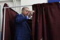 <p>Turkey’s President Recep Tayyip Erdogan enters a voting booth inside a polling station in Istanbul, Turkey, on Sunday, April 16, 2017. (AP Photo/Lefteris Pitarakis) </p>