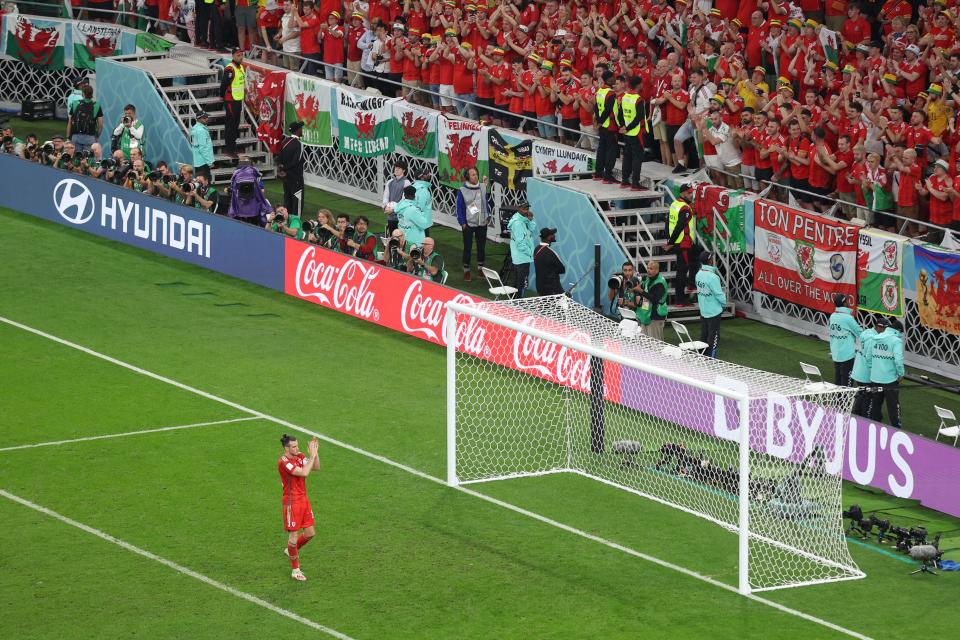 Wales' forward #11 Gareth Bale applauds the fans after the Qatar 2022 World Cup Group B football match between USA and Wales at the Ahmad Bin Ali Stadium in Al-Rayyan, west of Doha on November 21, 2022. (Photo by Adrian DENNIS / AFP) (Photo by ADRIAN DENNIS/AFP via Getty Images)