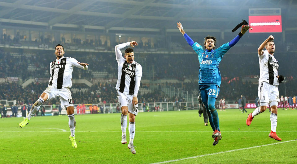 Juventus' players celebrate their victory at the end of the Italian Serie A soccer match against Torino FC at the Olimpico stadium in Turin, Italy, Saturday, Dec. 15, 2018. (Alessandro Di Marco/ANSA via AP)