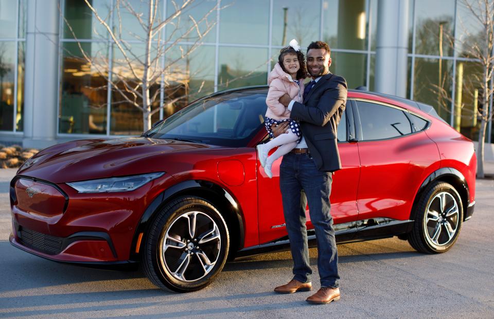 Josh Moore, a software engineer at Ford Motor Co., is seen here on Feb. 2, 2024, with his daughter Rose and the Mustang Mach-E. She inspired an Easter egg surprise that accompanies a sketch app in the Mustang Mach-E, F-150 Lightning, Ford Edge, Expedition and Ranger.