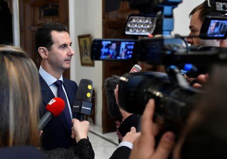 Syria's President Bashar al-Assad speaks to French journalists in Damascus, Syria, in this handout picture provided by SANA on January 9, 2017. SANA/Handout via REUTERS