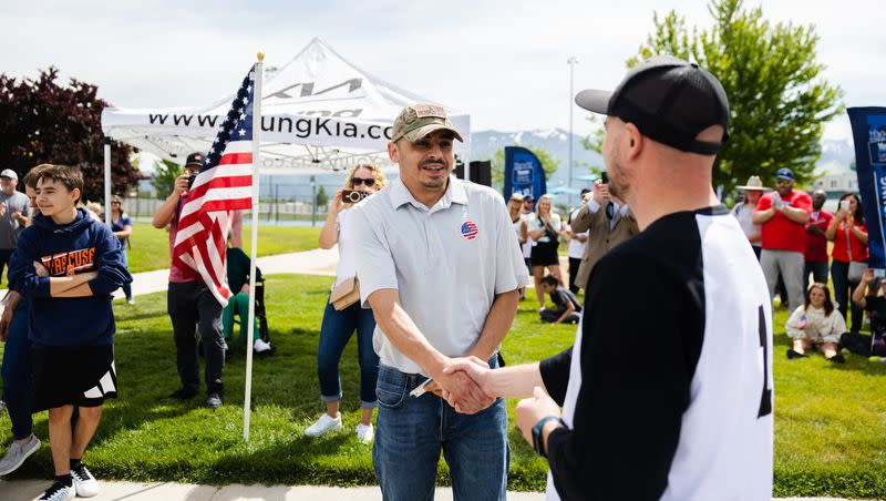 Retired U.S. Army Sgt. William Davis III accepts the keys to a new car at Ellison Park in Layton on June 17, 2023.