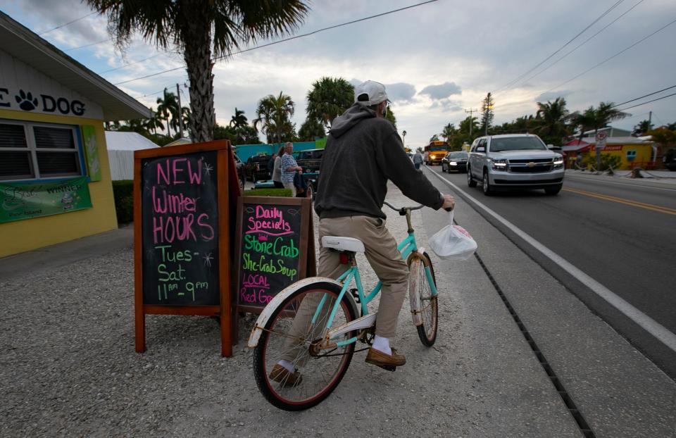 A local bicyclist rides west along Pine Island Rd. in Matlacha on Tuesday, February 15, 2022. The Florida Department of Transportation is looking to create a path through the island.