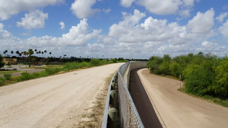 The border divide: a wall along one of the several layers of the US-Mexico border fencing in the border town of McAllen, Texas