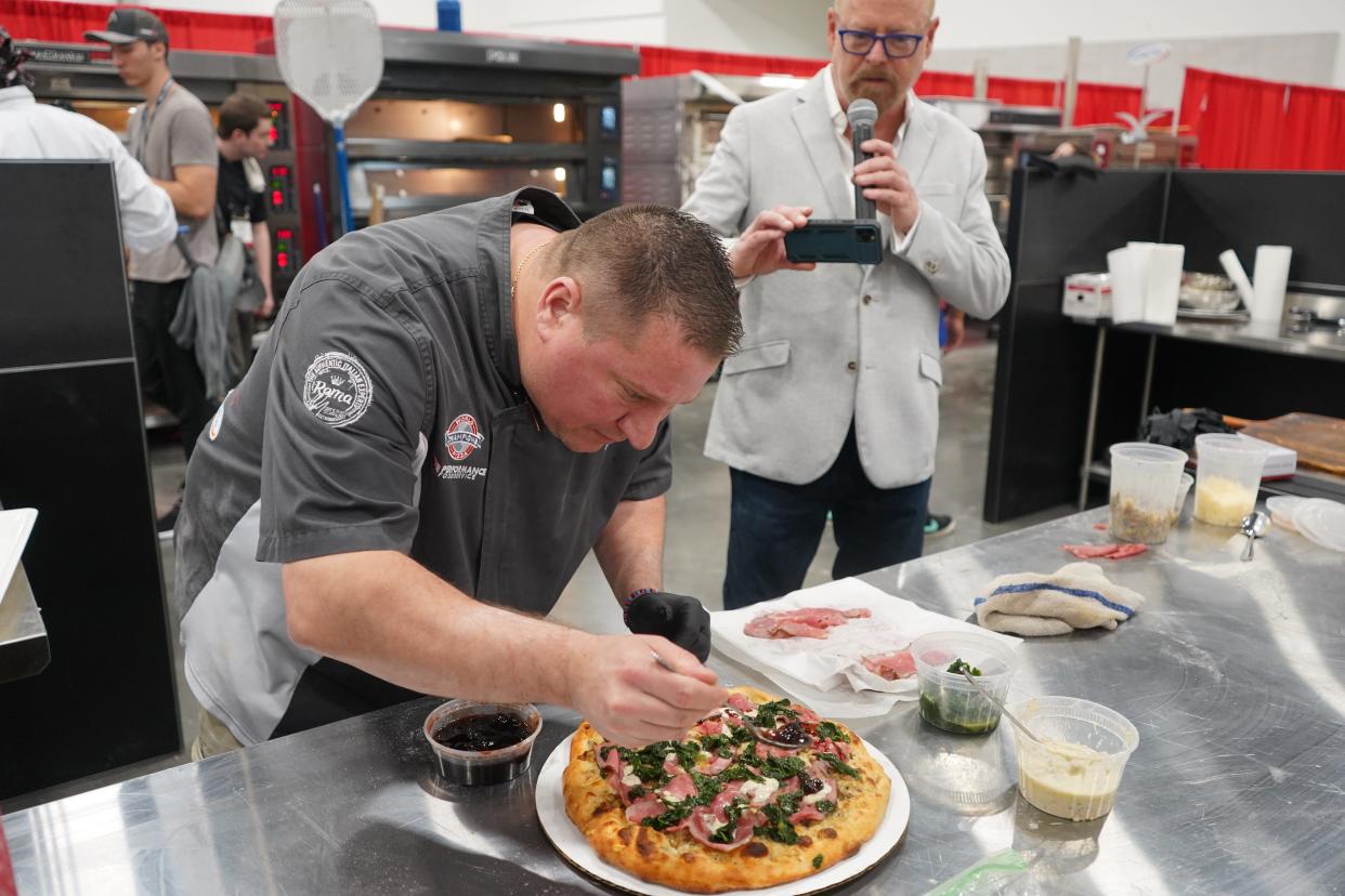 Caliente Pizza director of operations, Eric Von Hansen, with one of his award-winning pizzas.