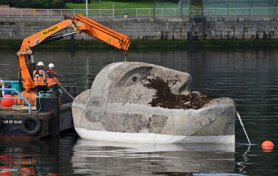 <p>The 27-tonne concrete and steel Floating Head sculpture by artist Richard Groom is moved into position on the River Clyde near the Glasgow Science Centre some 33 years after it was created for the Glasgow Garden Festival. Picture date: Monday August 23, 2021.</p>
