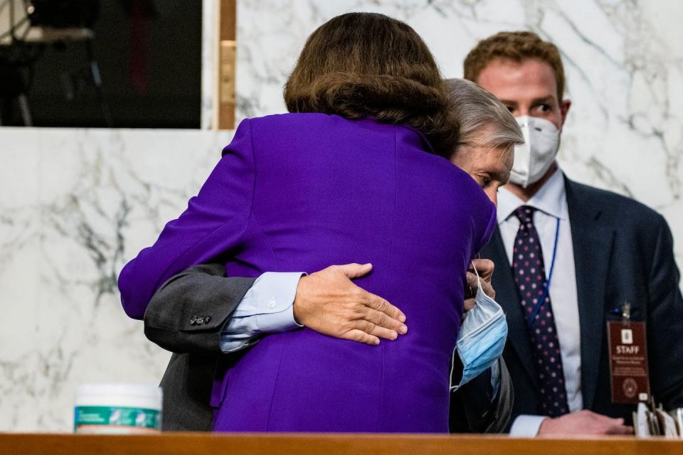 Dianne Feinstein hugs Republican Senator Lindsay Graham after the Amy Coney Barrett hearings, Oct. 15, 2020. <a href="https://www.gettyimages.com/detail/news-photo/ranking-member-diane-feinstein-and-chairman-lindsey-graham-news-photo/1229091483?adppopup=true" rel="nofollow noopener" target="_blank" data-ylk="slk:Samuel Corum / POOL / AFP via Getty;elm:context_link;itc:0;sec:content-canvas" class="link ">Samuel Corum / POOL / AFP via Getty</a>