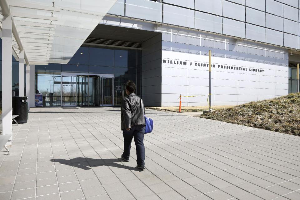 This photo taken March 13, 2014 shows a woman walking to the Clinton Presidential Library in Little Rock, Ark. The National Archives makes public another 4,000 pages of documents from the Clinton White House on Friday, including previously unreleased records related to Vice President Al Gore's 2000 presidential campaign and the 2000 recount in Florida. The records have been highly anticipated as former first lady Hillary Rodham Clinton considers a 2016 presidential campaign. (AP Photo/Danny Johnston)