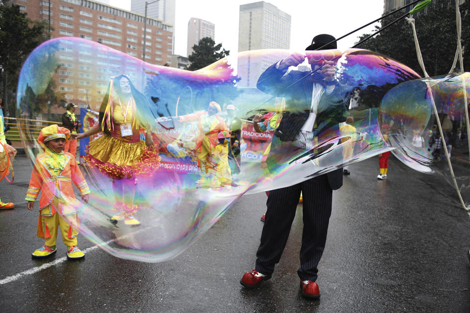 <p>A clown creates a huge bubble during an anti-government protest in Bogota, Colombia, May, 9, 2017. Members of the National Union of Circus Artists from across the country marched in Bogota to protest the government’s economic policies, demand better job opportunities and better access to healthcare. (Photo: Fernando Vergara/AP) </p>