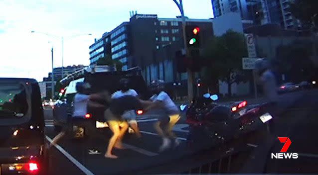 Outnumbered four to one, the motorist was kicked and punched as he tried to fight the gang off.  Source: 7 News