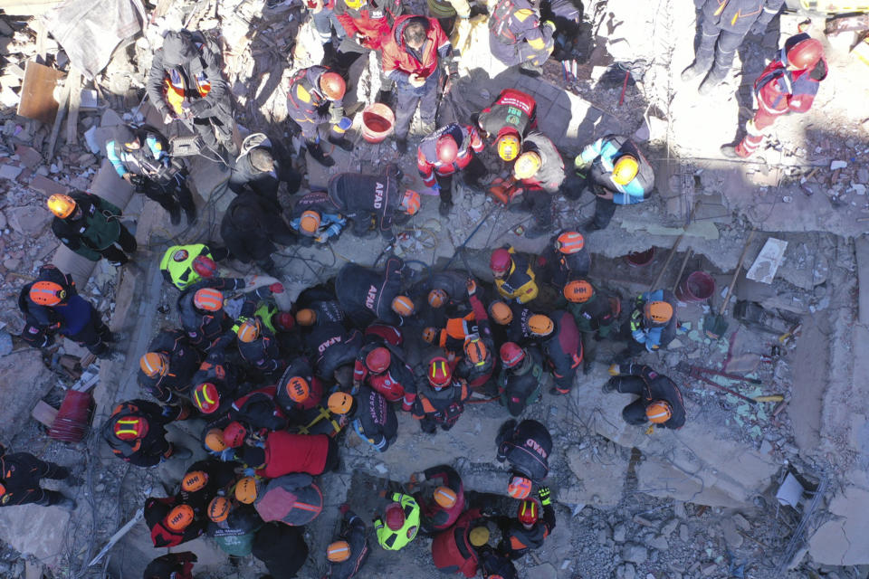 Rescuers work on searching for people buried under the rubble on a collapsed building, after an earthquake struck Elazig, eastern Turkey, Saturday, Jan. 25, 2020. Rescue workers were continuing to search for people buried under the rubble of apartment blocks in Elazig and neighbouring Malatya. Mosques, schools, sports halls and student dormitories were opened for hundreds who left their homes after the quake (IHH/ Humanitarian Relief Foundation via AP)