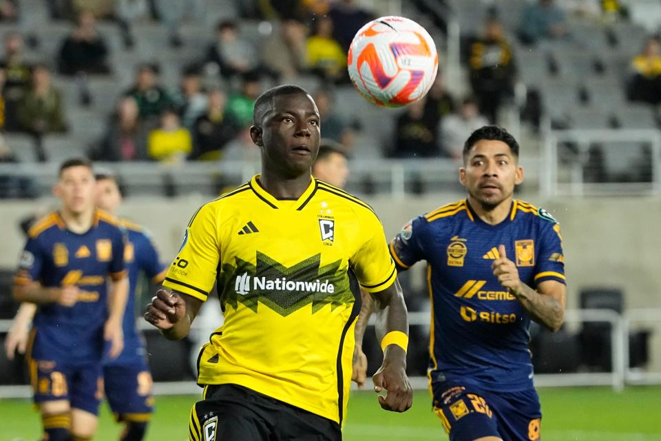 The Crew's Marino Hinestroza chases down a ball in front of Tigres midfielder Javier Aquino on Tuesday.