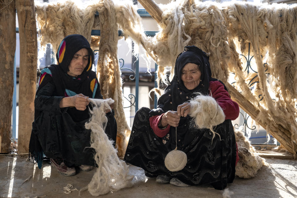 Afghan women weave wools for making carpets at a traditional carpet factory in Kabul, Afghanistan, Monday, March 6, 2023. After the Taliban came to power in Afghanistan, women have been deprived of many of their basic rights. (AP Photo/Ebrahim Noroozi)