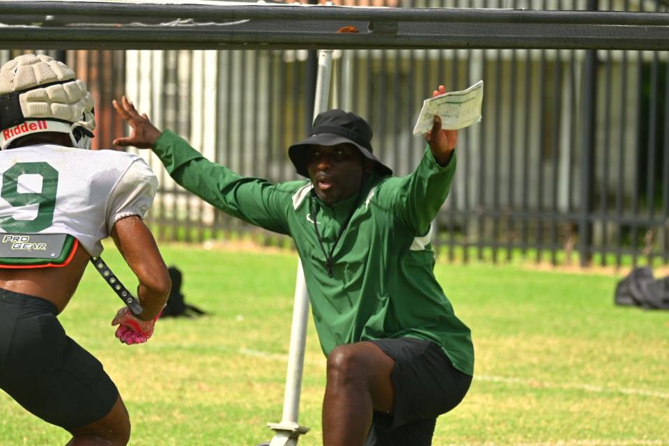 Florida A&M University defensive passing game coordinator and cornerbacks coach James Colzie III instructs cornerback Zaire Riley (9) in drill during fall training camp, Aug. 10, 2022