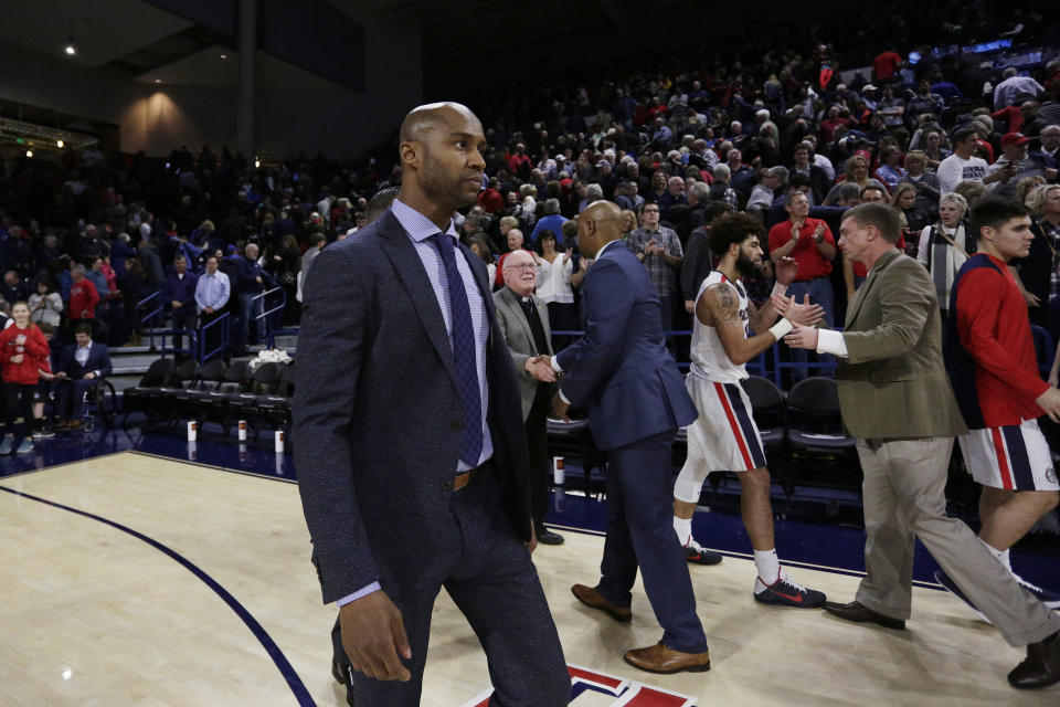 San Diego head coach Lamont Smith walks off the court after an NCAA college basketball game against Gonzaga in Spokane, Wash., Thursday, Feb. 1, 2018. (AP Photo/Young Kwak)