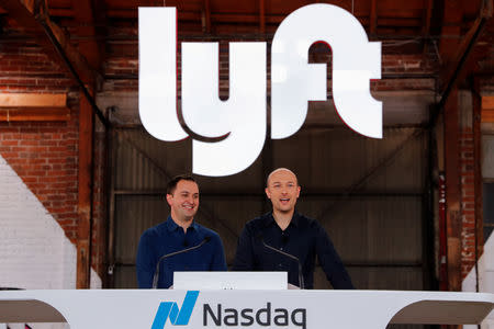 FILE PHOTO: Lyft President John Zimmer and CEO Logan Green speak as their company Lyft lists on the Nasdaq at an IPO event in Los Angeles, California, U.S. March 29, 2019. REUTERS/Mike Blake/File Photo