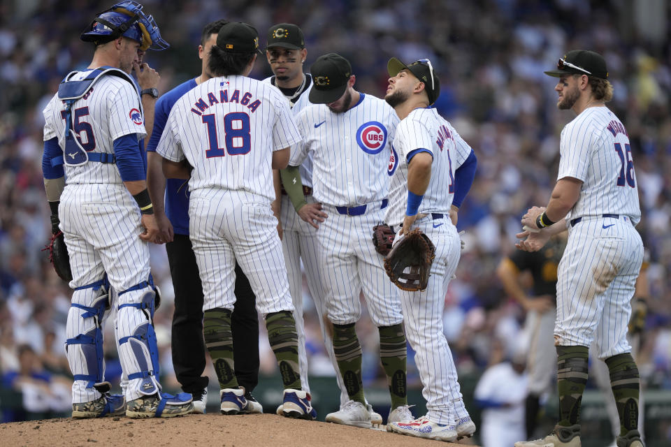 Chicago Cubs pitcher Shota Imanaga and the infield listen to pitching coach Tommy Hottovy during a mound visit in the seventh inning of a baseball game against the Pittsburgh Pirates, Saturday, May 18, 2024, in Chicago. (AP Photo/Charles Rex Arbogast)