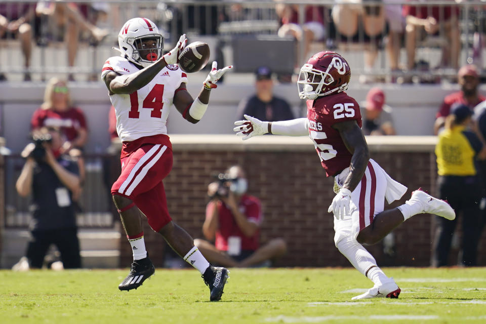 Nebraska running back Rahmir Johnson (14) catches a pass in front of Oklahoma defensive back Justin Broiles (25) in the first half of an NCAA college football game, Saturday, Sept. 18, 2021, in Norman, Okla. (AP Photo/Sue Ogrocki)