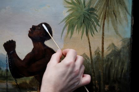 David Crombie, Senior Paintings Conservator at the National Museums, Liverpool carries out restoration work on the painting 'Am Not I A Man And A Brother', one of only 2 known paintings of its type in existence in Liverpool, Britain, July 30, 2019. Picture