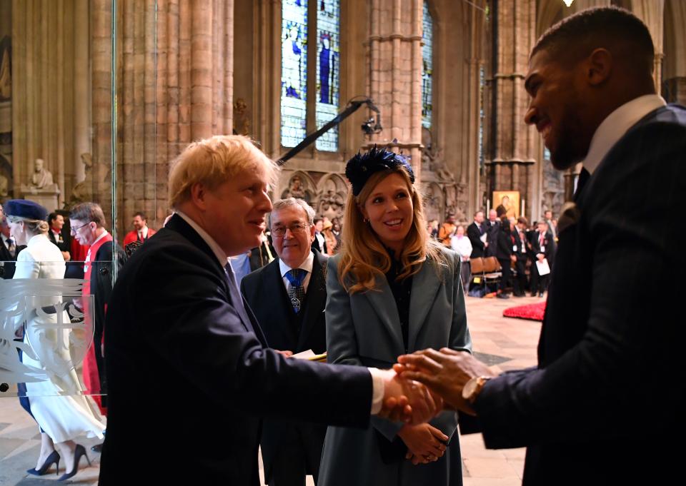 LONDON, ENGLAND - MARCH 09:  Britain's Prime Minister Boris Johnson and his fiancee partner Carrie Symonds talk with British boxer Anthony Joshua as they leave after attending the Commonwealth Day Service 2020 on March 9, 2020 in London, England. (Photo by Ben Stansall-WPA Pool/Getty Images)