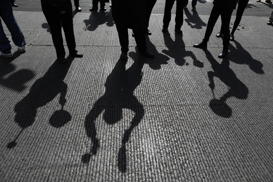 FILE - In this Jan. 12, 2021 file photo, the shadows of restaurant workers banging metal pots are cast on the street as more than a hundred employees from multiple restaurants block an intersection in the Polanco neighborhood to protest COVID-19 "red alert" restrictions that have closed on-site dining in Mexico City. Mexico City's government announced on Friday, May 7, 2021 that public hospitals dedicated to fighting COVID-19 is experiencing its lowest rate occupancy of the pandemic and the city is slightly easing some restrictions, more than three months after COVID-19 infections peaked in the Mexican capital. (AP Photo/Rebecca Blackwell, File)